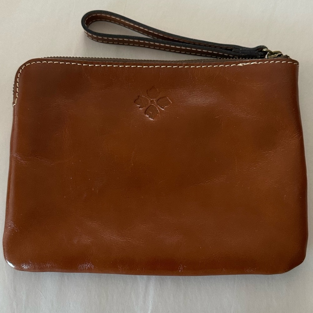 Patricia Nash brown leather 6.5 by 9 zipper and pockets wristlet purse.